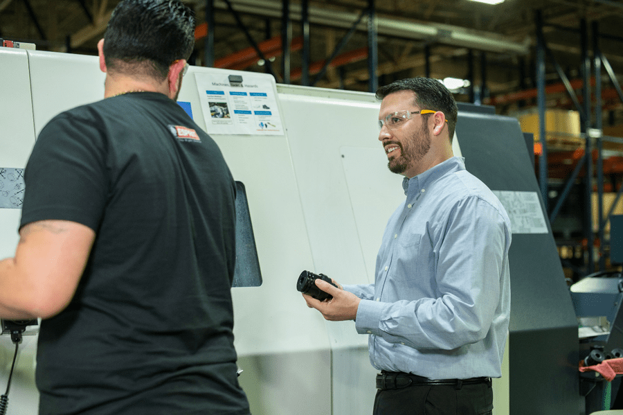 Programmer Alejandro Perez (left) and manufacturing manager Justin Henry (right), working on the Citizen Miyano ABX-51TH3.