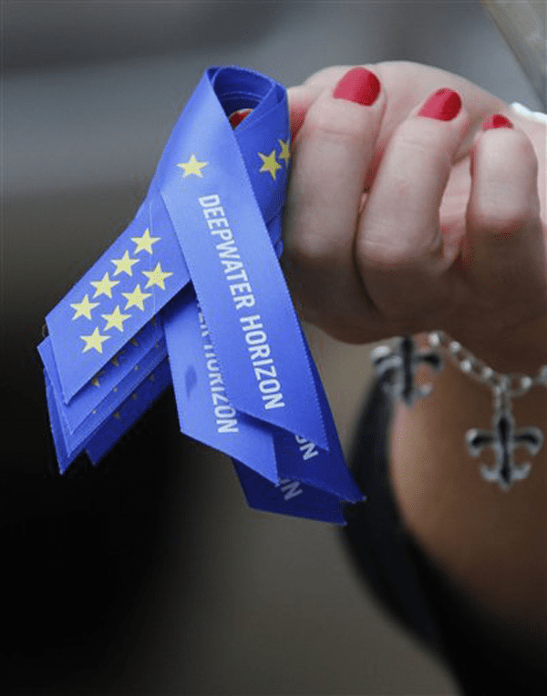 A woman who asked not to be identified holds ribbons with eleven stars that were given attendees to the memorial service honoring the eleven men who died in the offshore rig explosion that triggered the Gulf oil spill, Tuesday, May 25, 2010 in Jackson, Miss. Attendees listened to tributes from country music stars and drilling company executives. Photo courtesy of Alabama Media Group. Photo courtesy of Alabama Media Group – read the full story here: www.al.com/live/2010/05/victims_of_deepwater_horizon_e.html