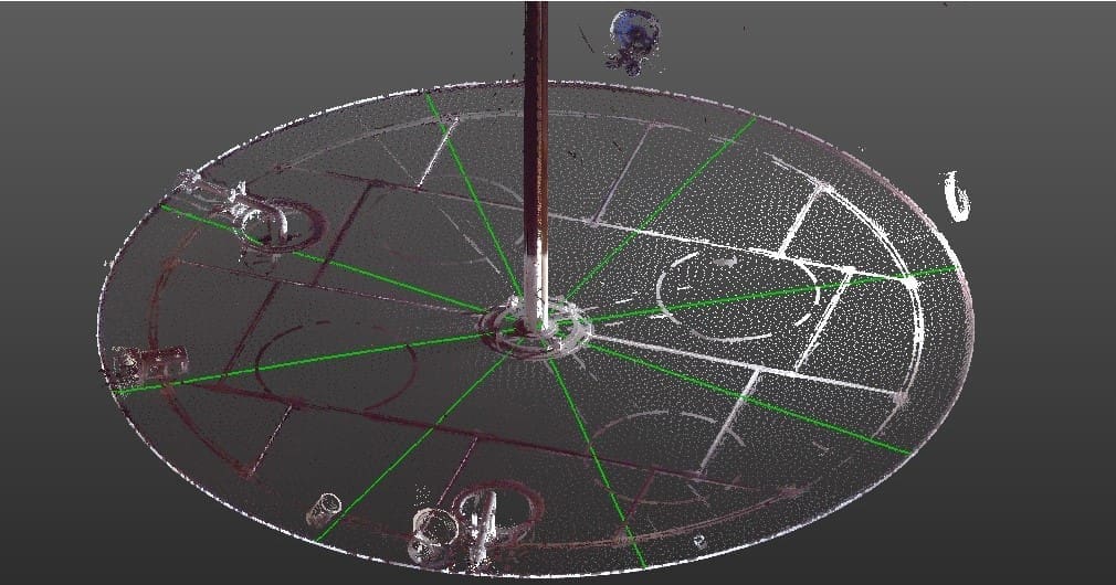 Scanner data of tank interior showing floor and interior piping. White dots indicate individual measurements on the floor.