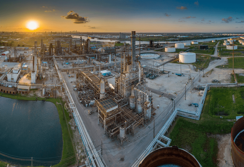 The sun sets over this Houston ship channel refinery and tank field. A panoramic photo taken from the air.