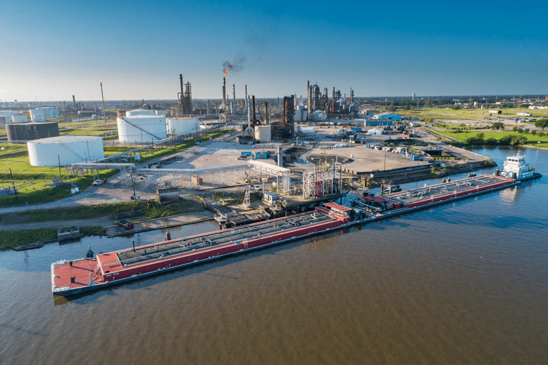 Oil offloading to the waiting vessel at this ship channel terminal and then on to the market.