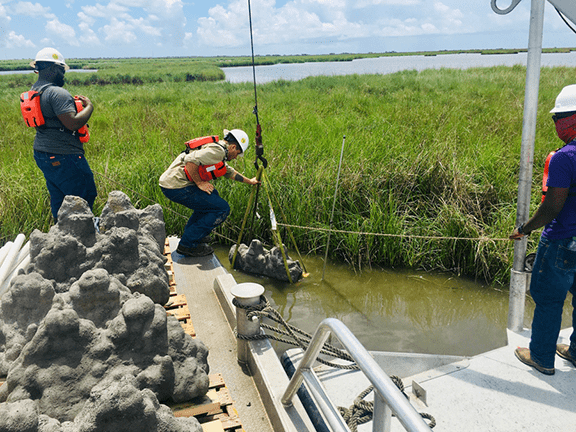 Danos has partnered with North Carolina-based Natrx on several nature-based coastal restoration projects. Here, a team installs a reef structure, known as Cajun Coral, into the marsh of Golden Meadow, La.