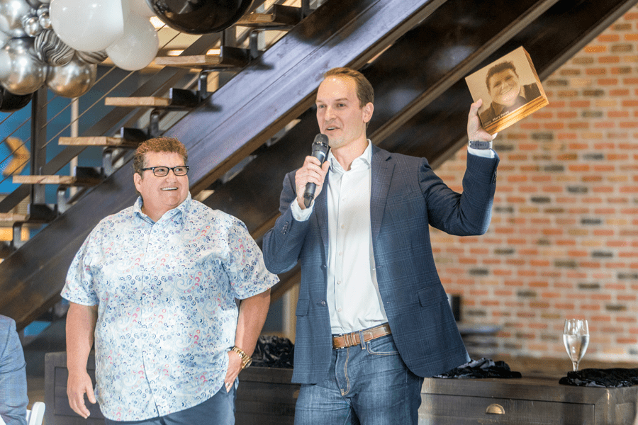 Paul Danos presents 2020 Employee of the Year winner Mary Perez with a wooden block for her to place on the Danos Employee of the Year Wall at headquarters. The Employee of the Year Wall honors all Danos employee of the year winners.