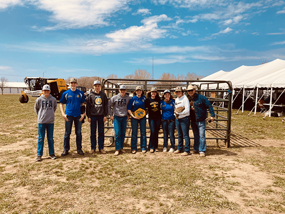 A group of FFA students poses with The Earth’s Championship belt. Each received The Crude Life hats for engagement and hospitality.