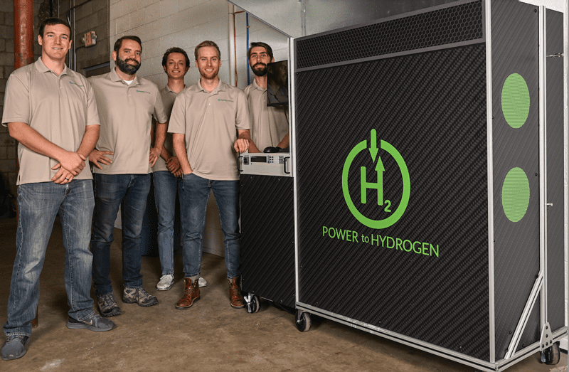 Power to Hydrogen team with their 10kW electrolyzer capable of producing enough hydrogen to fuel a hydrogen vehicle. Team from left to right: Travis Hery, engineering director; Paul Matter, CEO; Charlie Wiswesser, engineering intern; Alex Zorniger, VP of business development; and Matt Middlekamp, senior engineer.