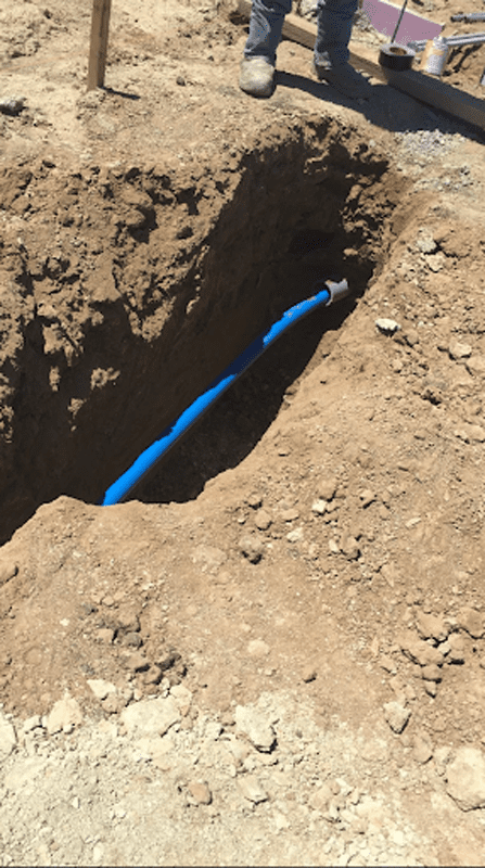 Compressed air piping buried in trench.