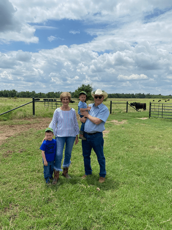 Rick and Gail Muncrief checking cattle with their grandsons.