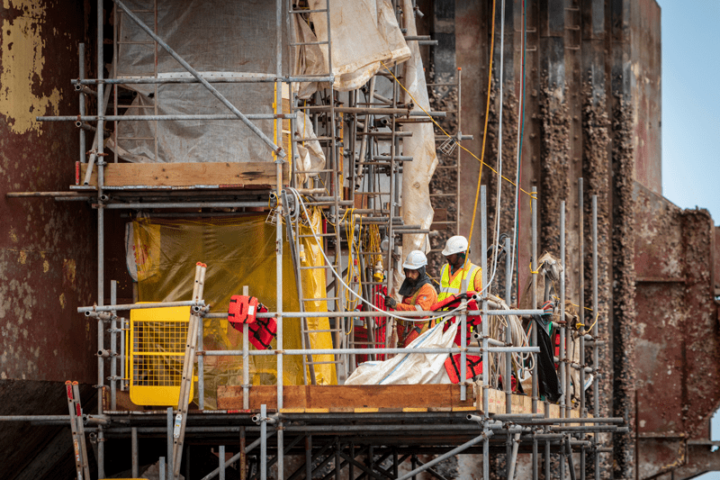 Workers examining scaffolding in Walvis Bay, Namibia.