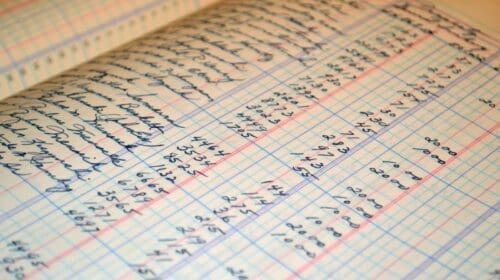 Close-up of a vintage handwritten ledger detailing financial records and accounts.