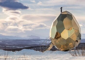 golden solar egg-shaped building in snow