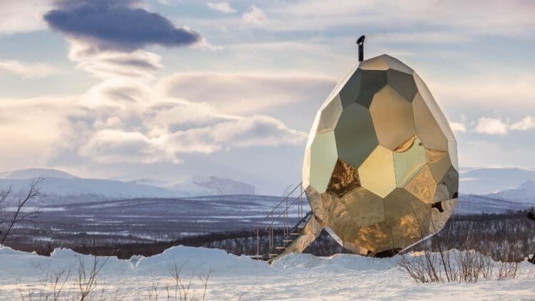 golden solar egg-shaped building in snow