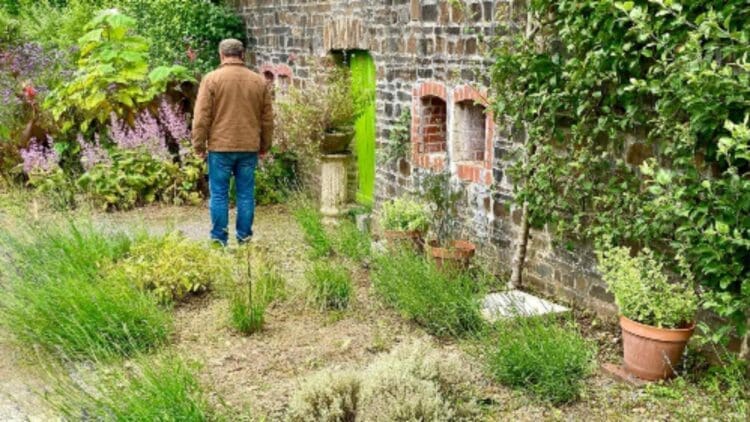 Most homes rely on concrete or brick walls — A Denver engineer built one that cuts electricity use by 89% 1 man walking past wall