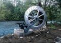 A Canadian man built a water wheel and ended up generating enough energy to power a home using only friction and gravity 3 water wheel next to river