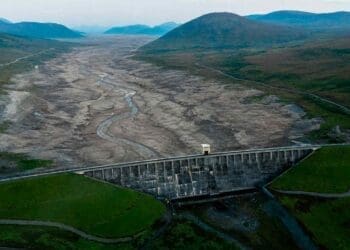 a hydroelectric dam's dried up reservoir