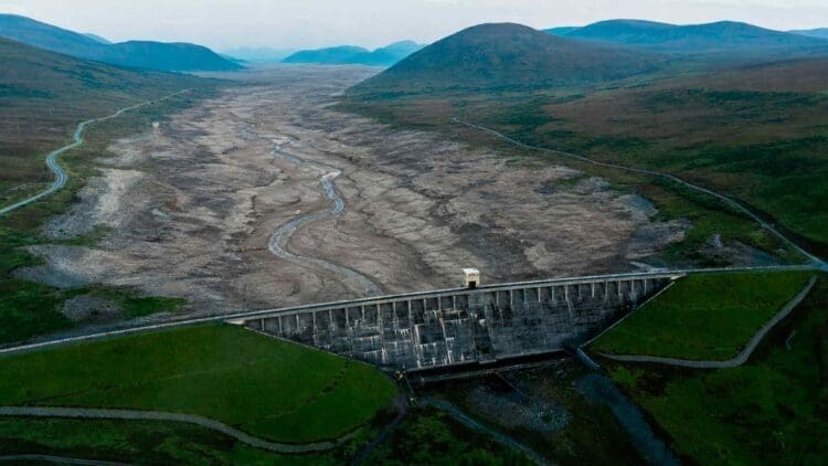 a hydroelectric dam's dried up reservoir