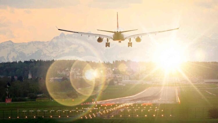 plane in takeoff over glaring solar farm