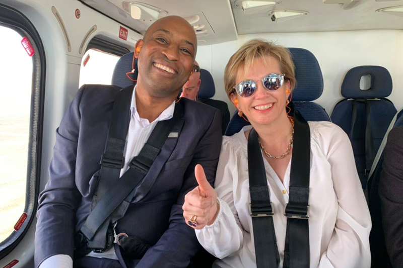 En route by helicopter to customer sites in Kuwait, Borras gives an all-clear with Tayo Akinokun, regional vice president of Middle East, Northern Africa and India for Oilfield Services at Baker Hughes. (2019)