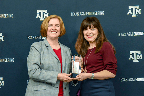 Dr. M. Katherine Banks, the first female president of Texas A&M, presents Aleida Rios (‘91) with the 2019 Outstanding Alumni Honor Award from the College of Engineering. Photo courtesy of Aleida Rios.