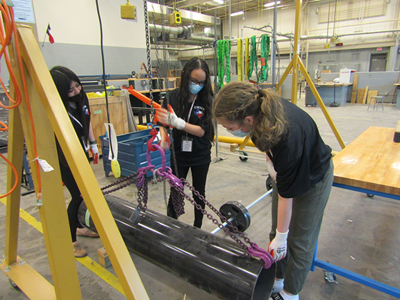 Using the rigging system in the back shop at Wunsche High School.