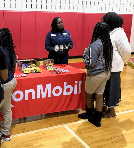 Pre-COVID-19, MLK Middle School, one of ExxonMobil’s partner schools in Beaumont, would have an annual STEM night and invite companies and organizations to showcase something STEM related. Using rubber band cars, Erika Anderson talks about the conservation of energy principle and what engineers do.