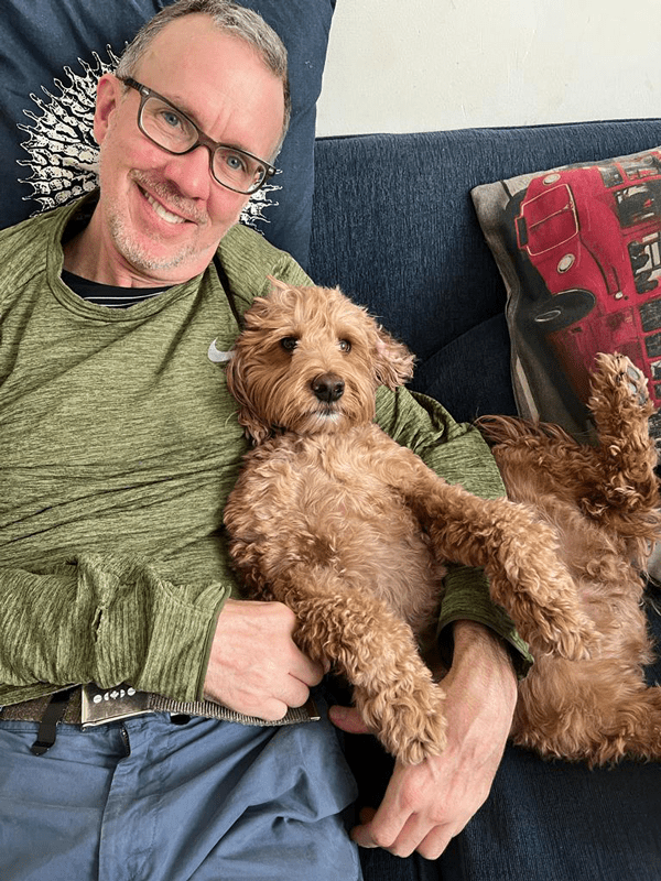 Andy Taylor relaxing at home with Marley, the family’s Cockapoo.