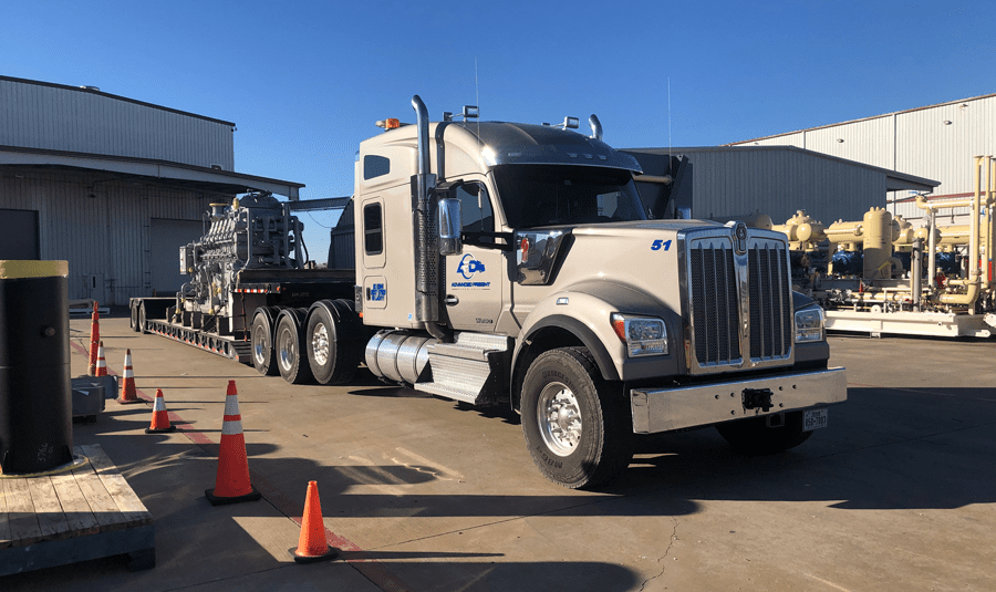 Hauling a compressor engine to a drilling site.