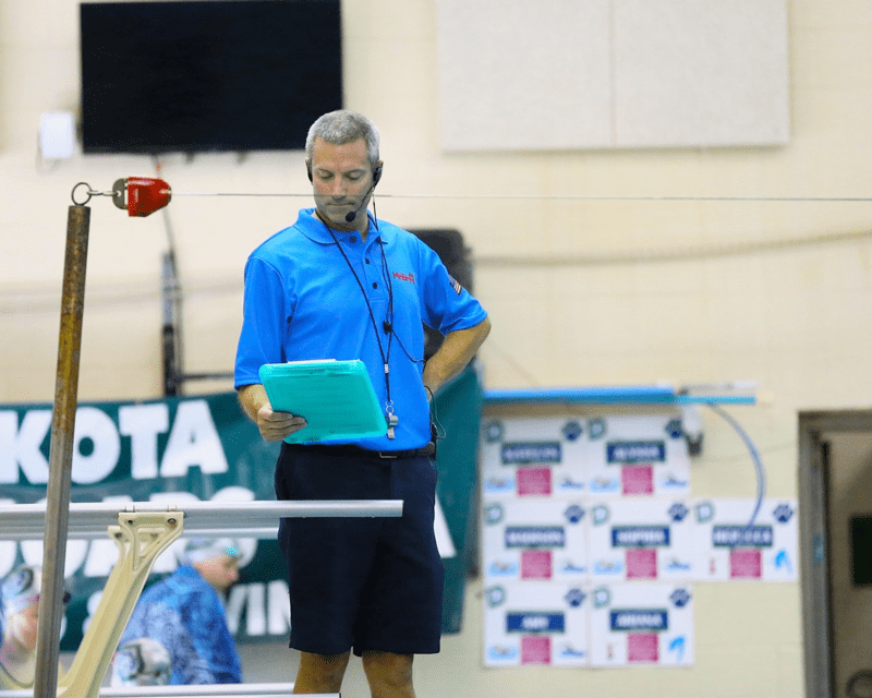 Rob officiating a swim meet. Photo courtesy of the The Macomb Daily.